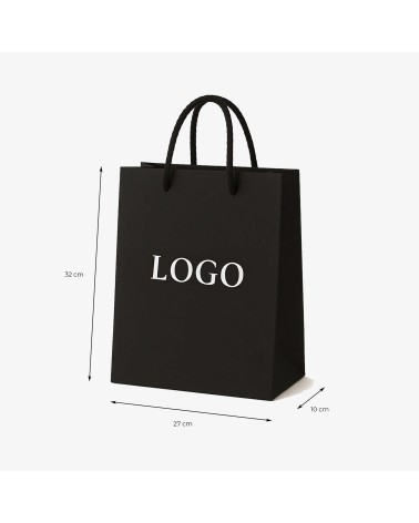 Sac cadeau noir grand format avec logo fini blanc gravé à chaud, pratique et élégant